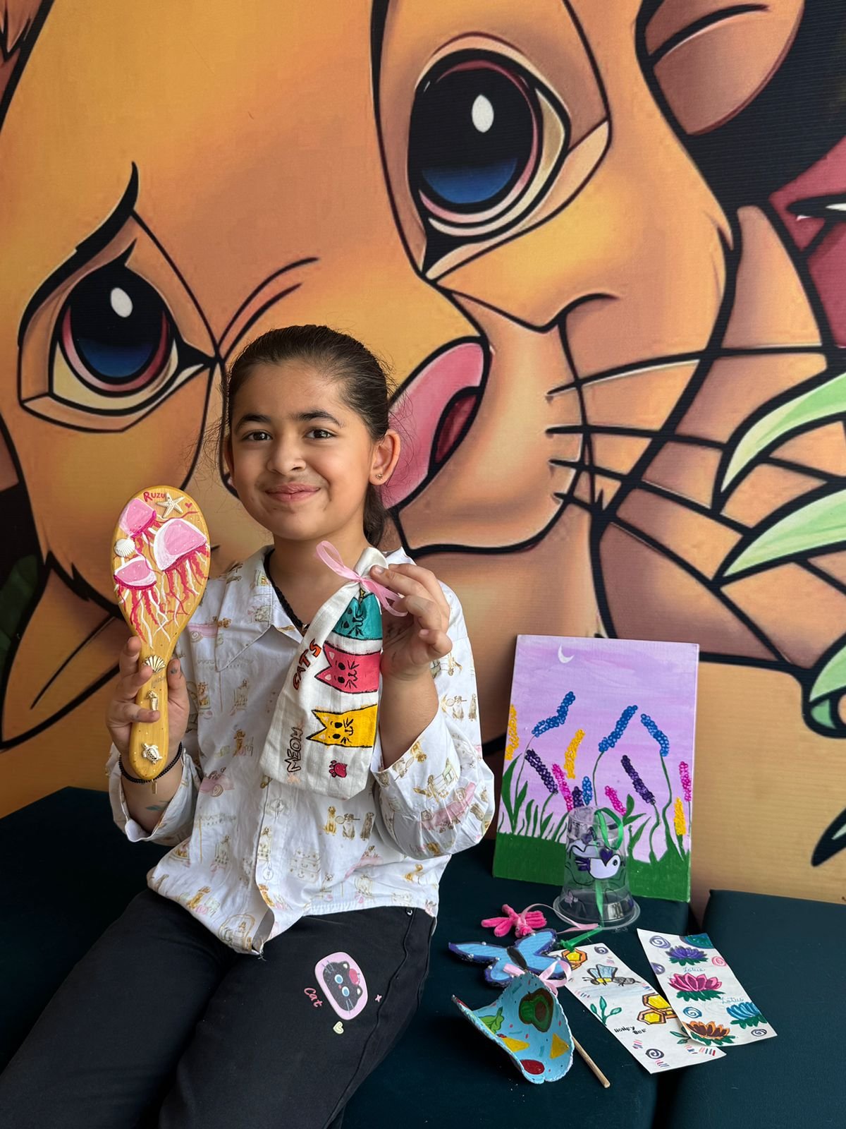 A girl with her painted hairbrush and cat-themed craft set